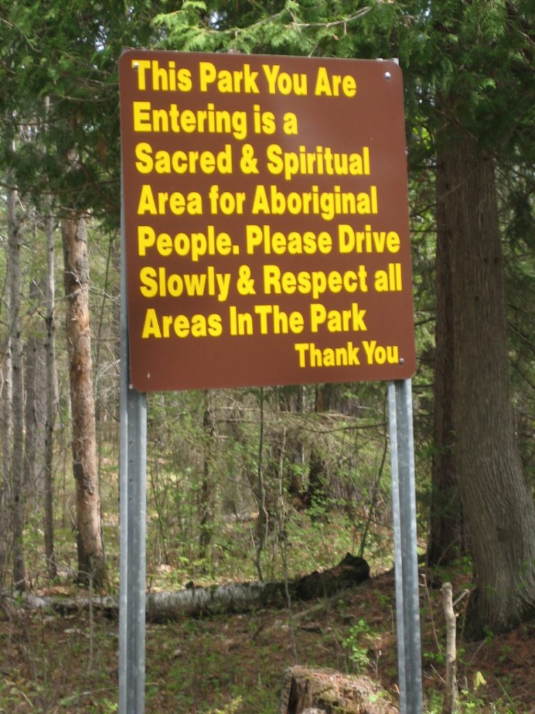 Picture of a panel at the entrance to the Petroglyphs Provincial Park, reminding visitors that the Park is a spiritual and sacred site to Indigenous peoples